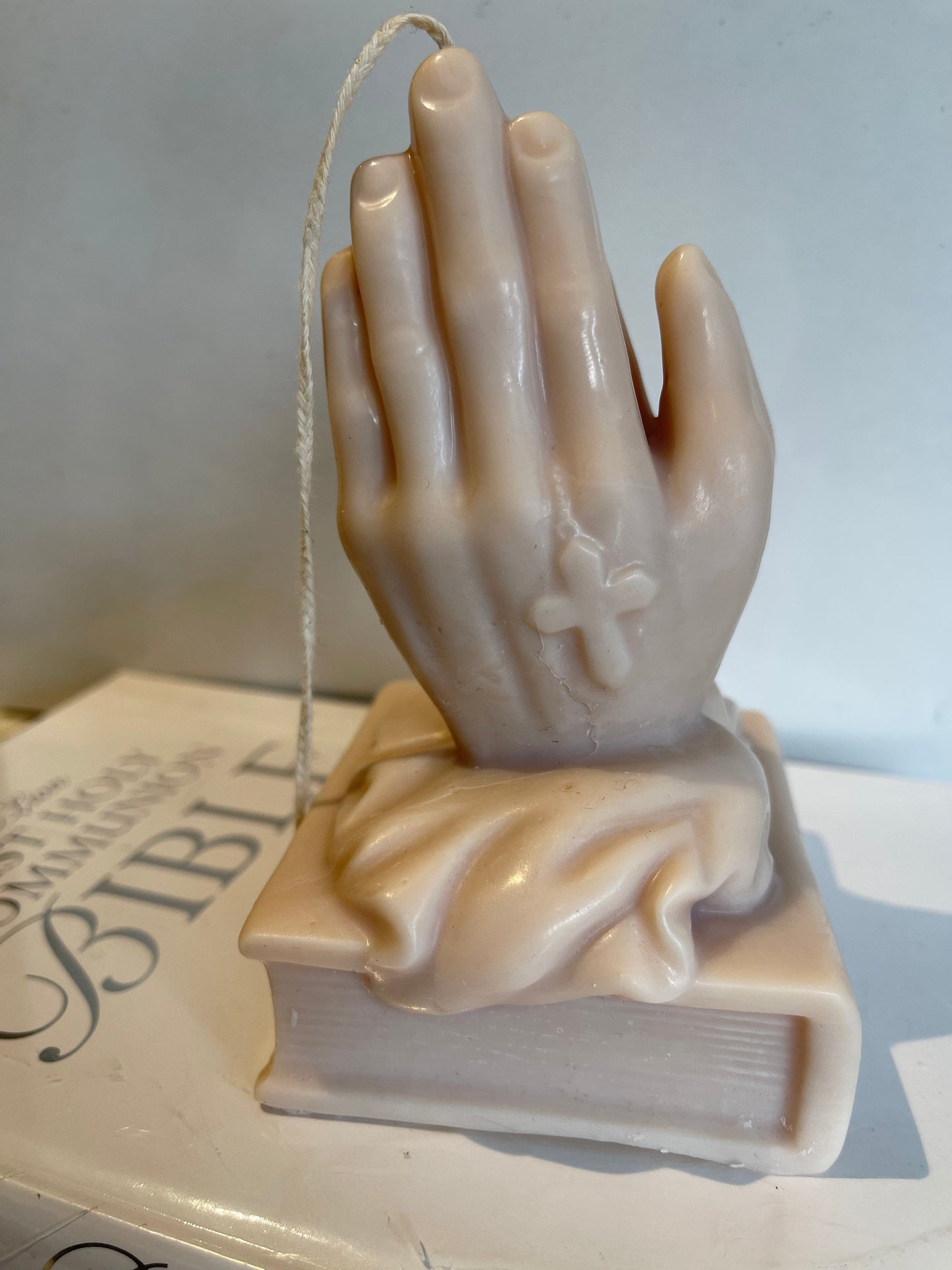 Praying Hands on Bible Candle